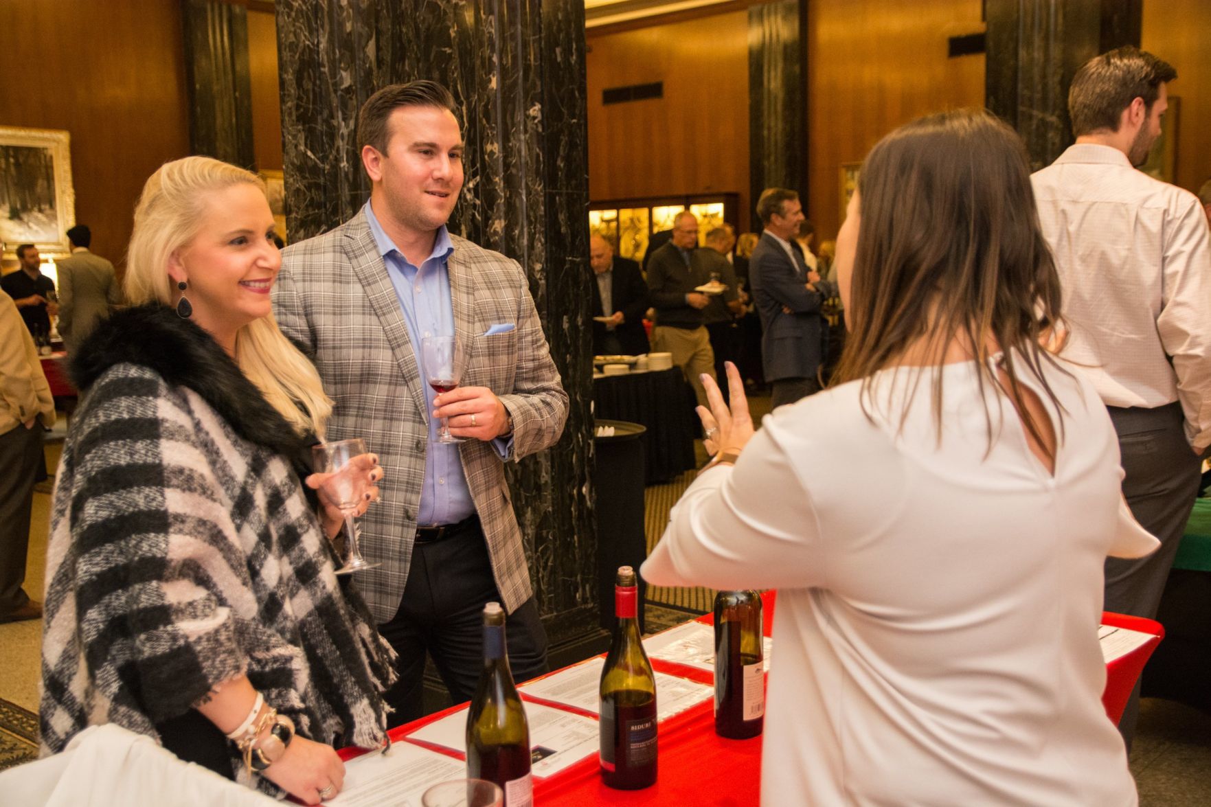 Julia Stricker, Danny Stricker talk about wine with a wine representative